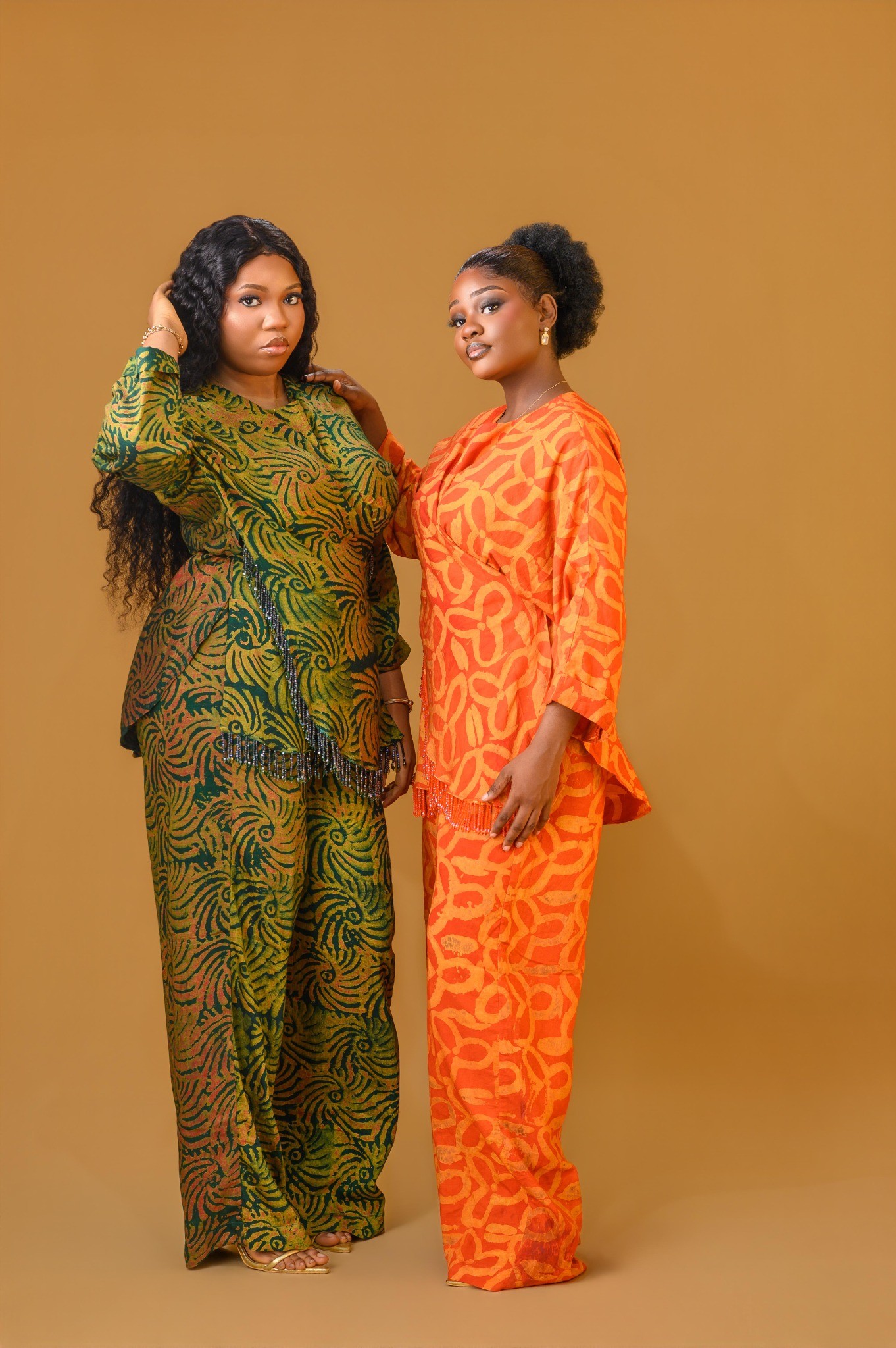Two ladies wearing the Vivienne set in Green and Orange colour