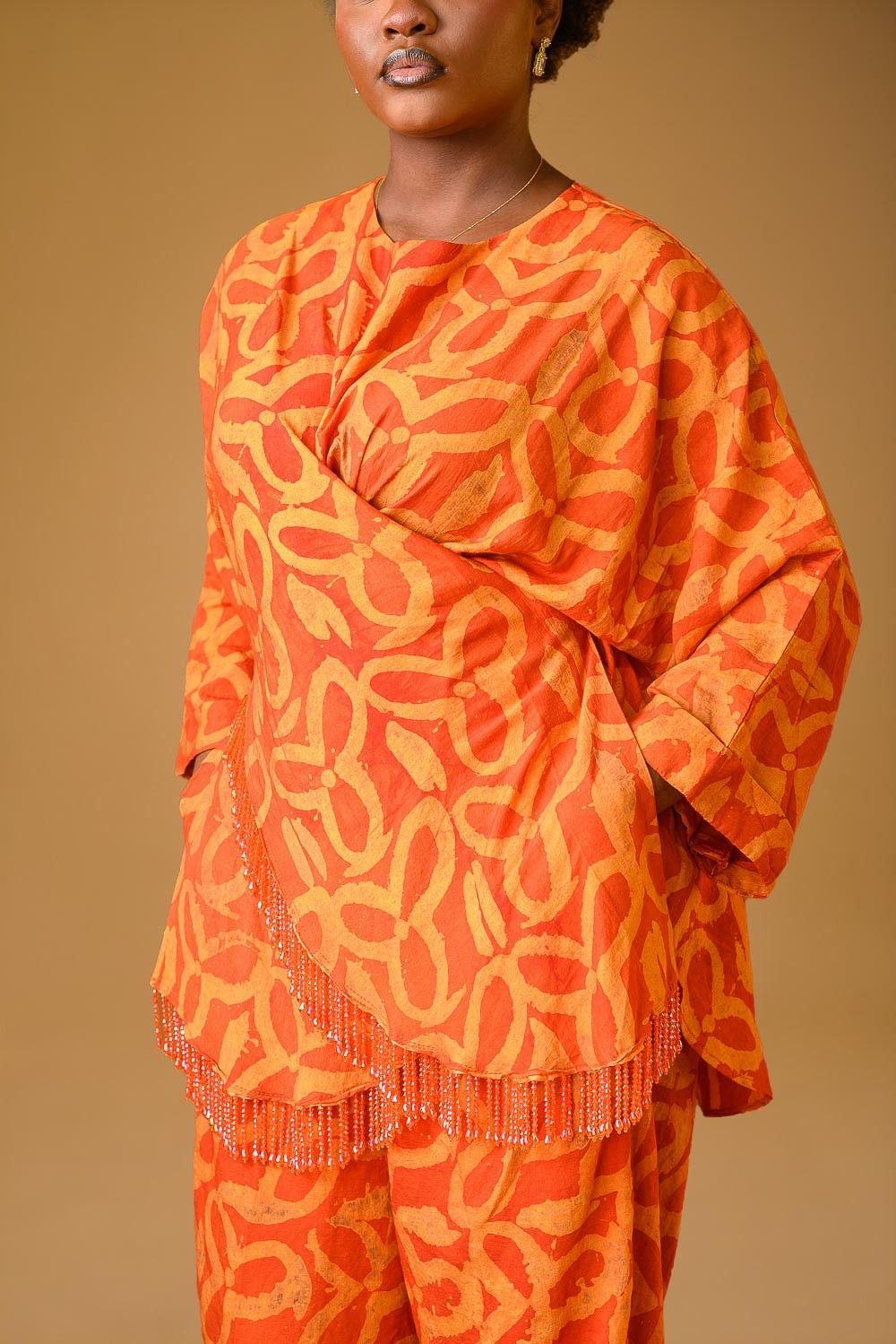 A zoomed in photo of a lady wearing the Vivienne set in Orange colour