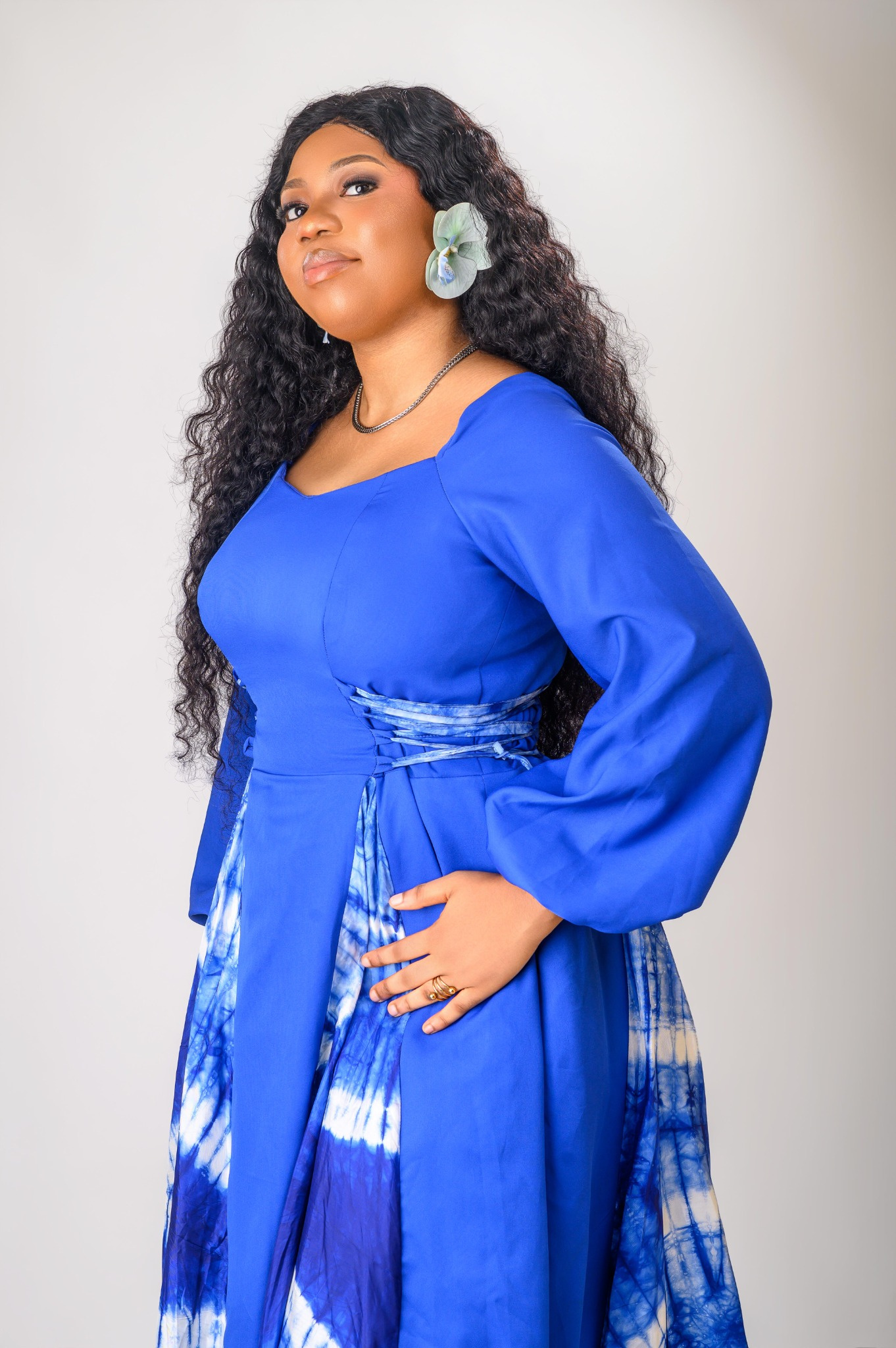 A lady wearing the Zuri dress in blue