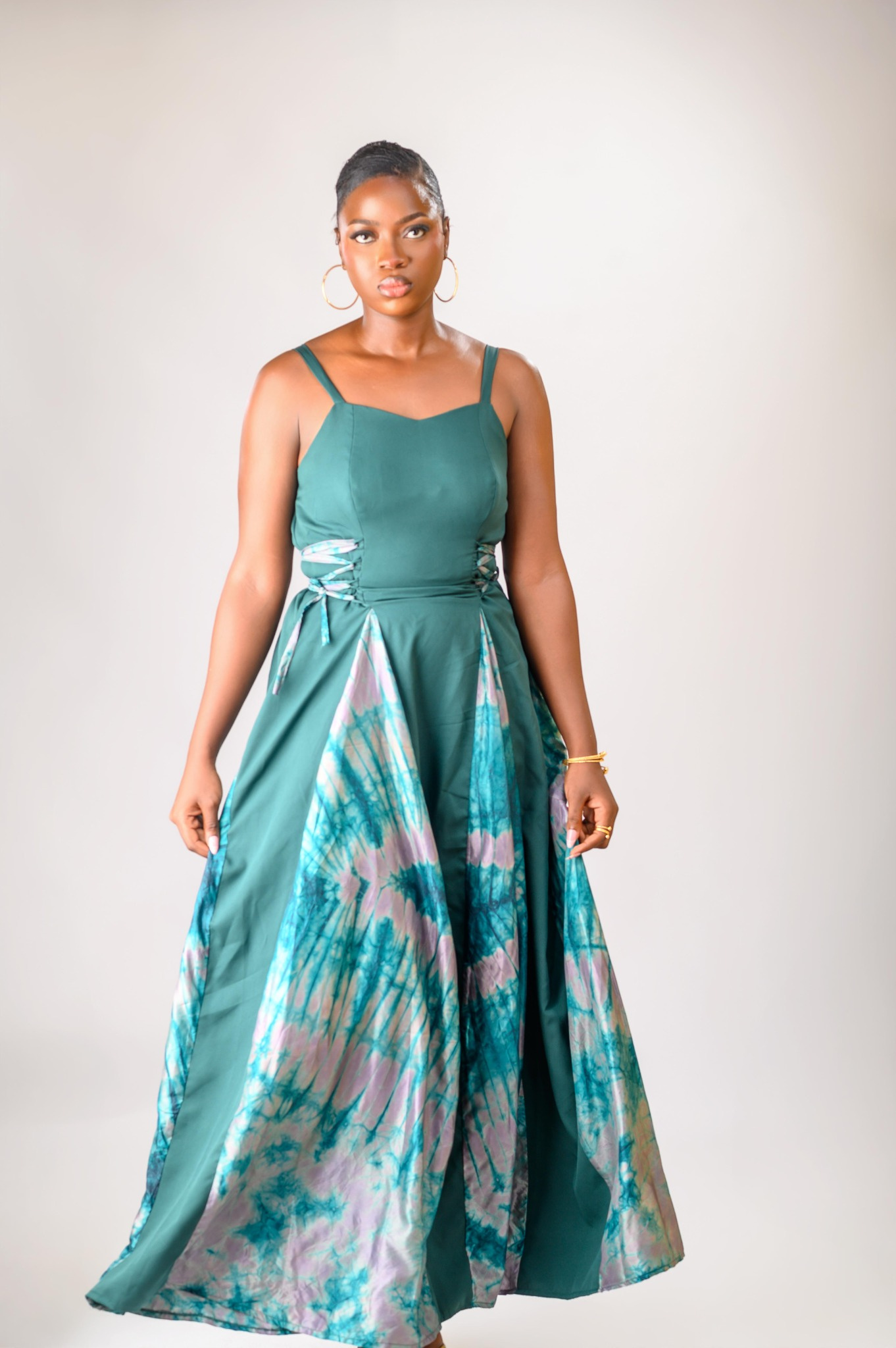 A lady wearing the Zuri dress in green colour