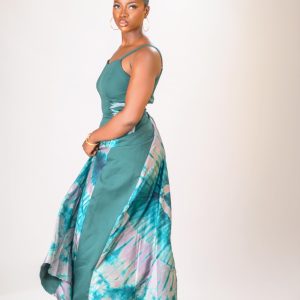 A lady wearing the Zuri dress in green colour
