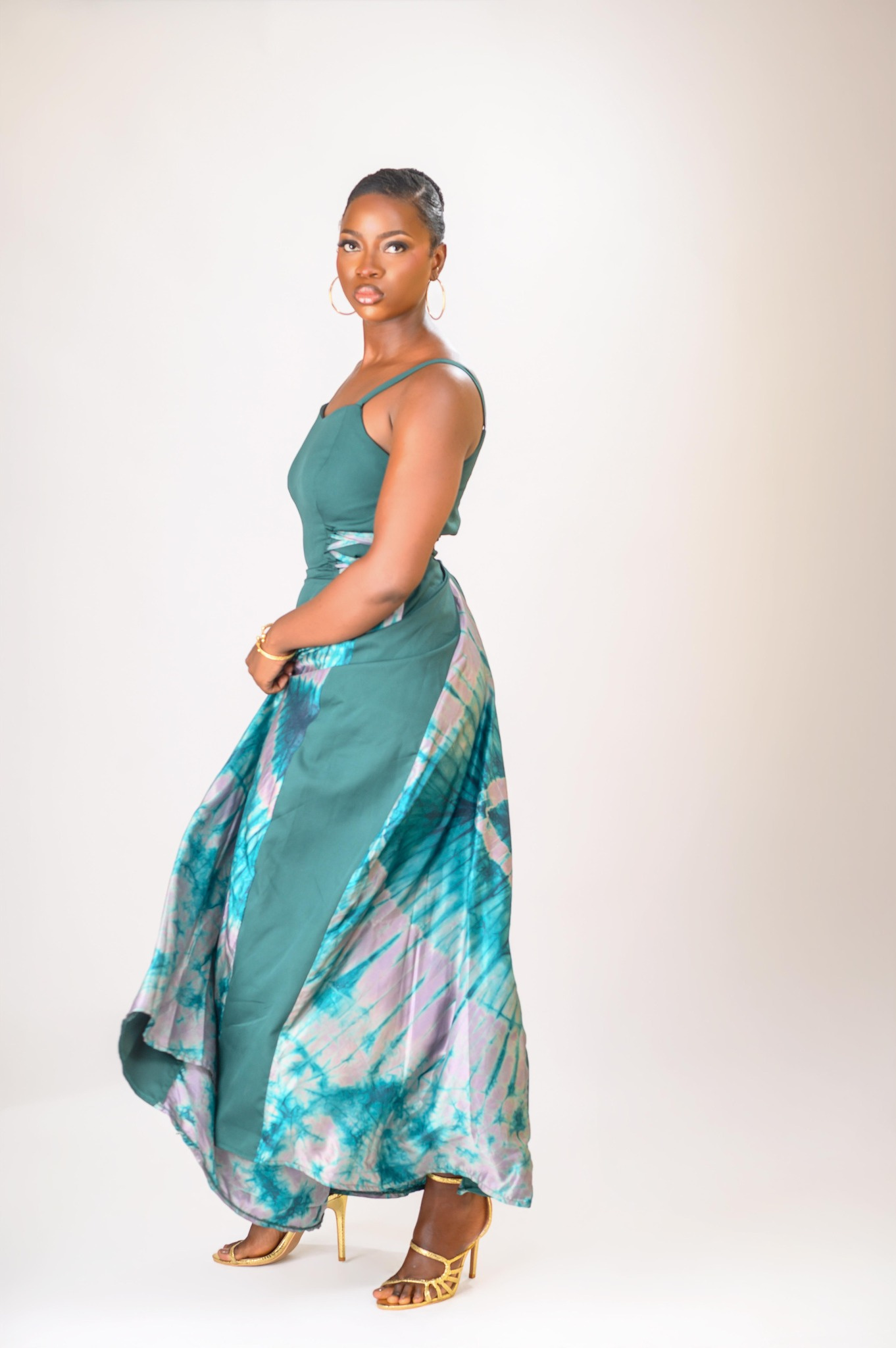 A lady wearing the Zuri dress in green colour