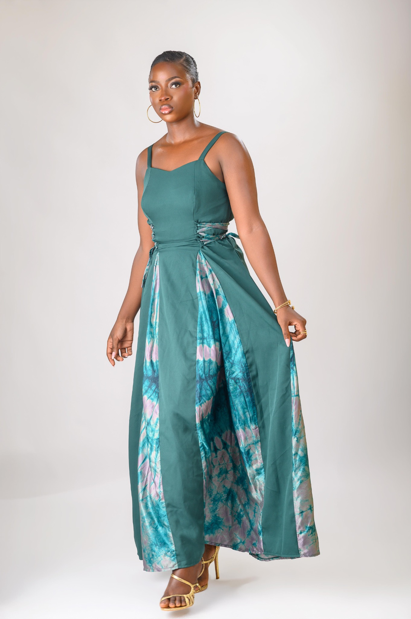 A lady wearing the Zuri dress in green colour