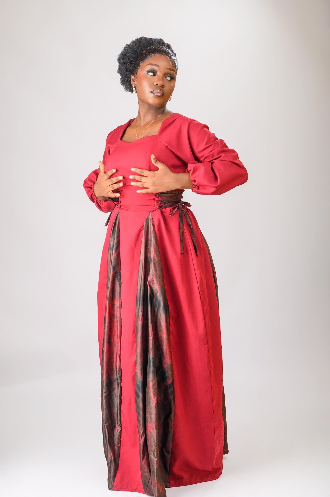 A lady wearing the Zuri dress in red colour