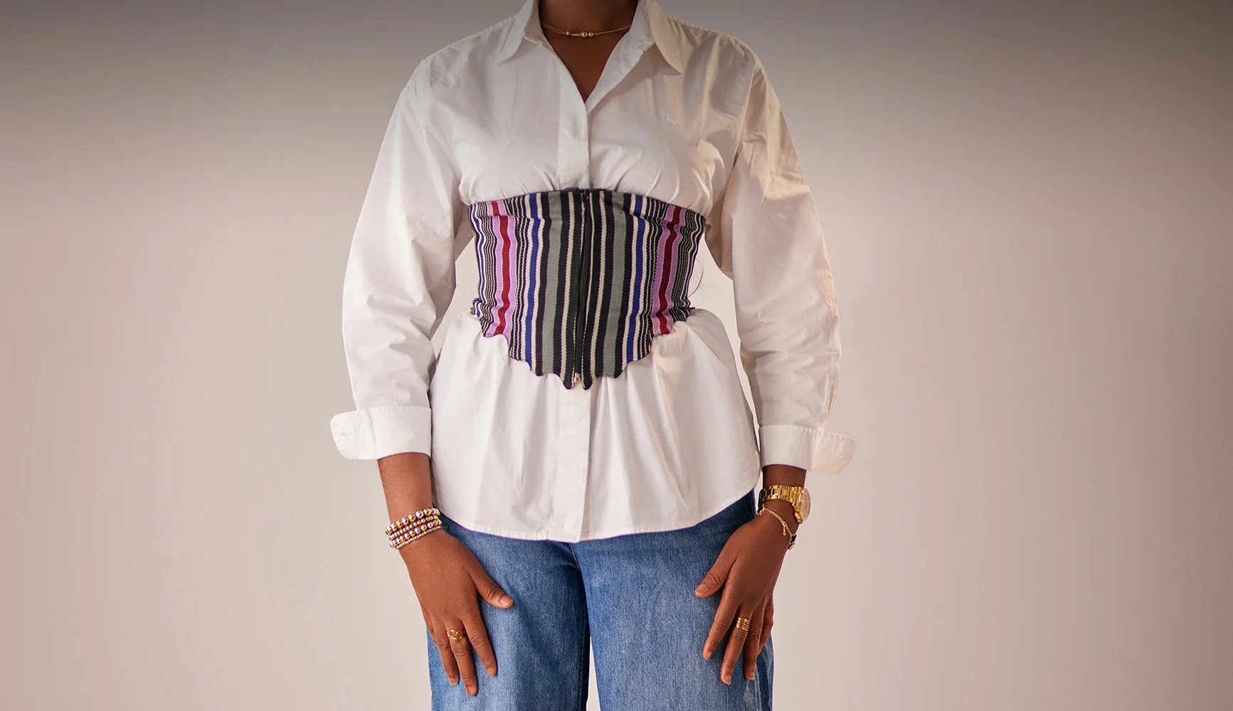 A lady wearing aso oke waistcoat and cargo pants
